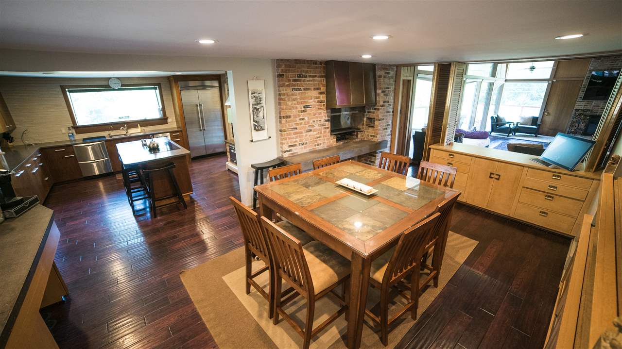 3802 Brookview Road Rockford, IL 61107 - Photo 8 of 25 a kitchen with stainless steel appliances granite countertop a stove a refrigerator a kitchen island dining table and chairs