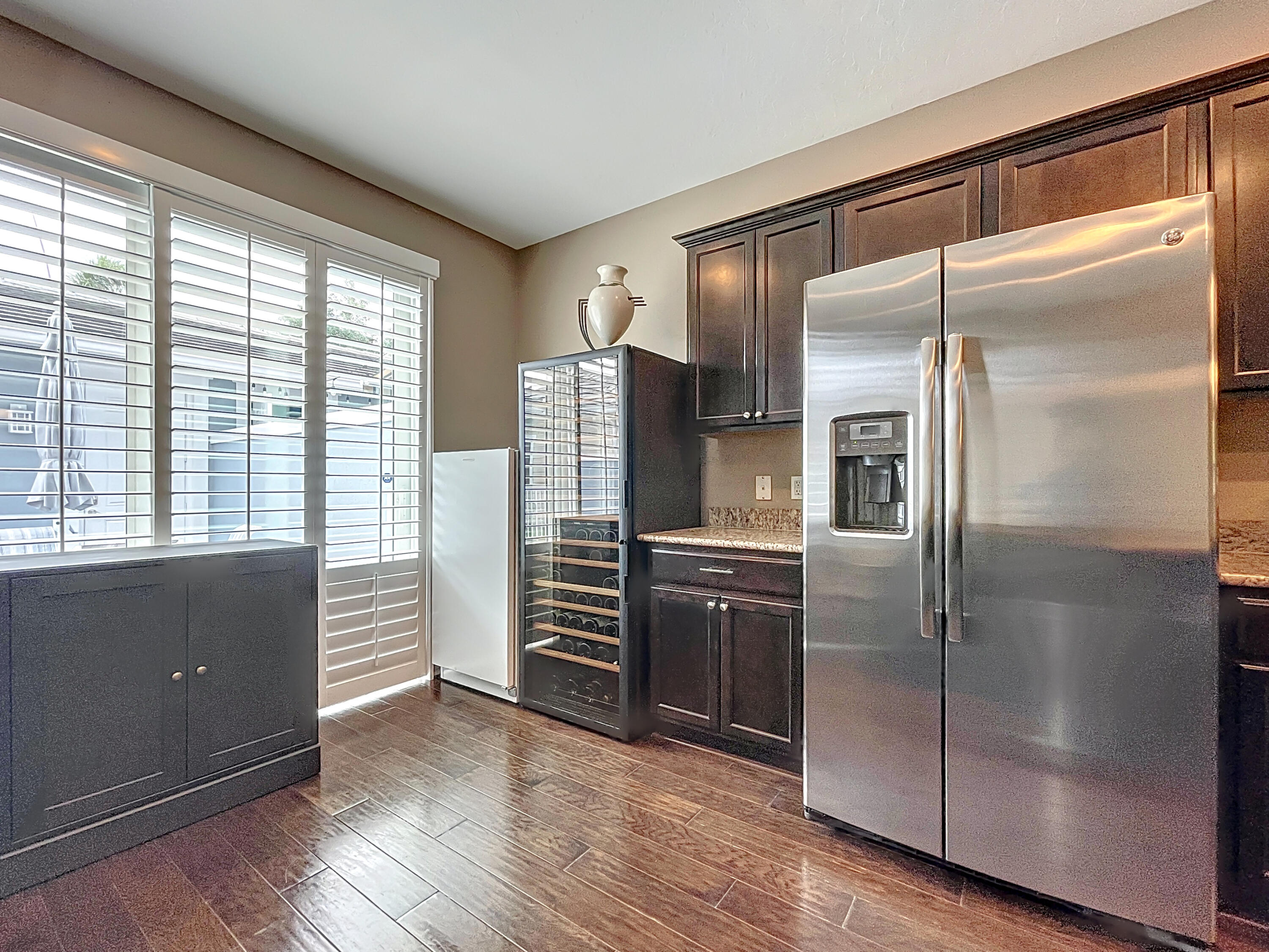 2742 Avalon Way Jupiter, FL 33458 - Photo 12 of 48 a kitchen with stainless steel appliances a refrigerator and a wooden floor