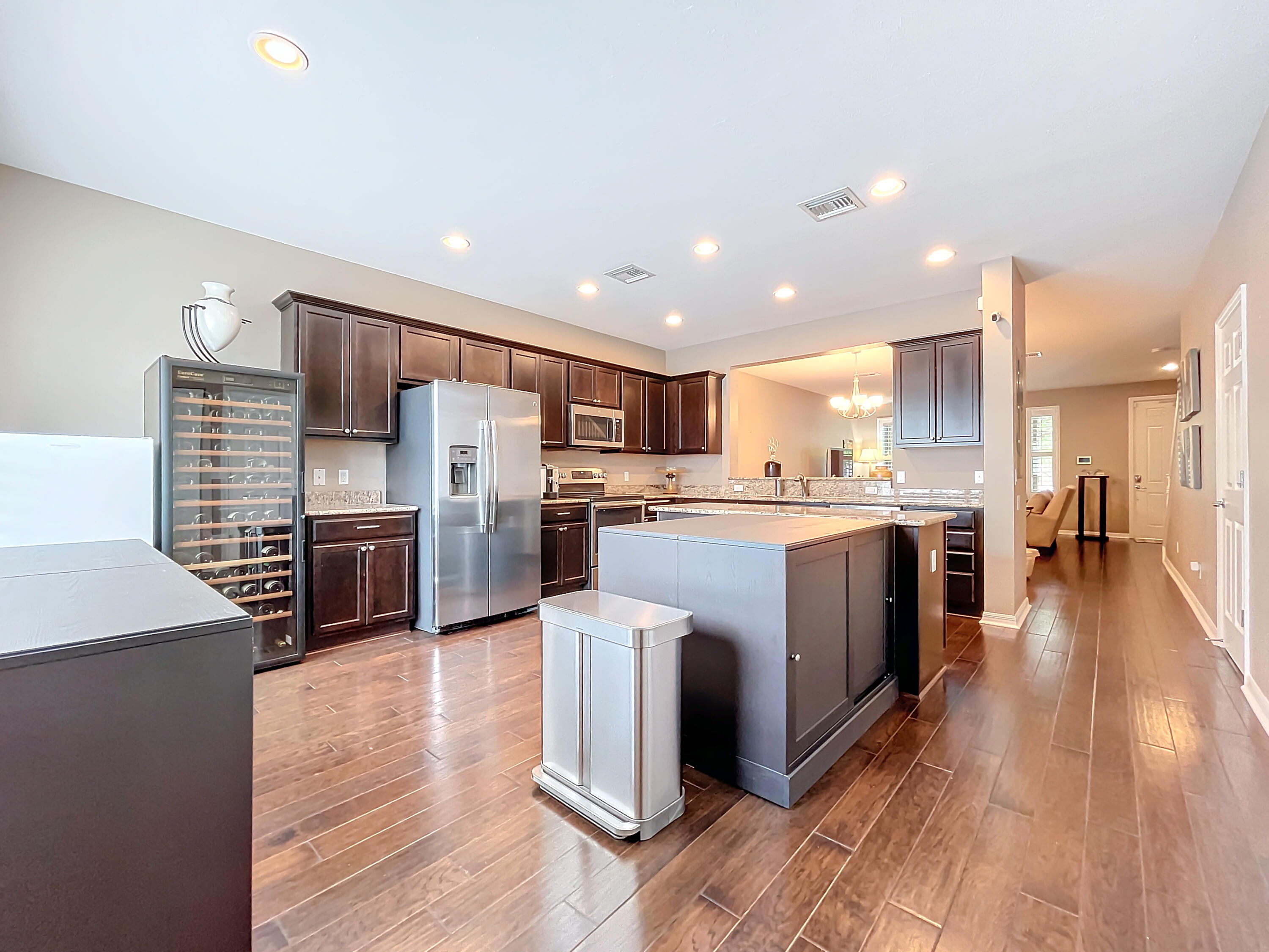 2742 Avalon Way Jupiter, FL 33458 - Photo 13 of 48 a large kitchen with stainless steel appliances kitchen island granite countertop a large counter top stainless steel appliances and cabinets