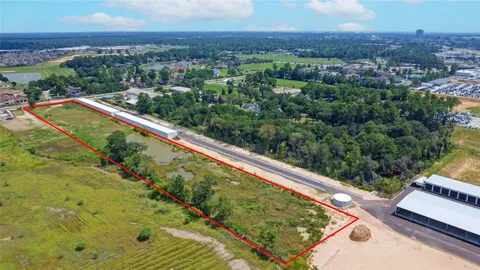 a view of a pool with a table and chairs