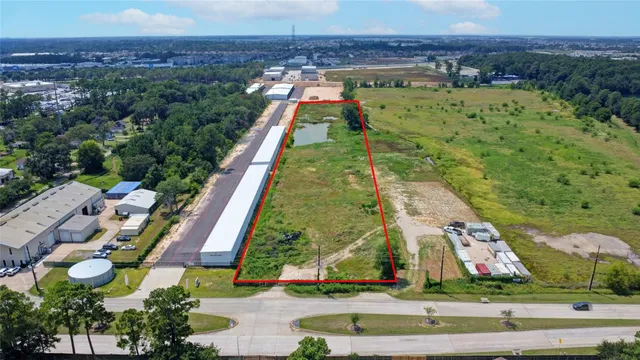 an aerial view of residential houses with outdoor space and parking