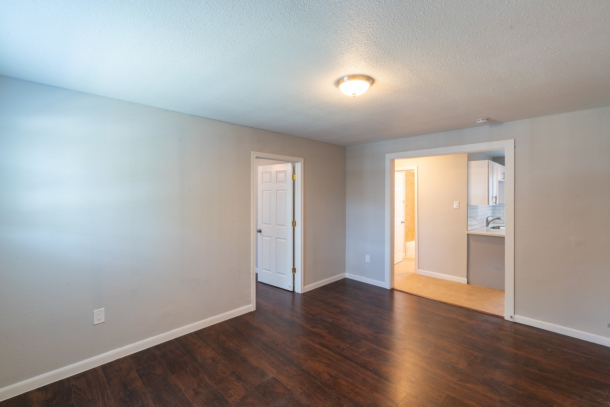 2503 Delano Street, Unit 4 Houston, TX 77004 - Photo 1 of 10 a view of an empty room with wooden floor and a window