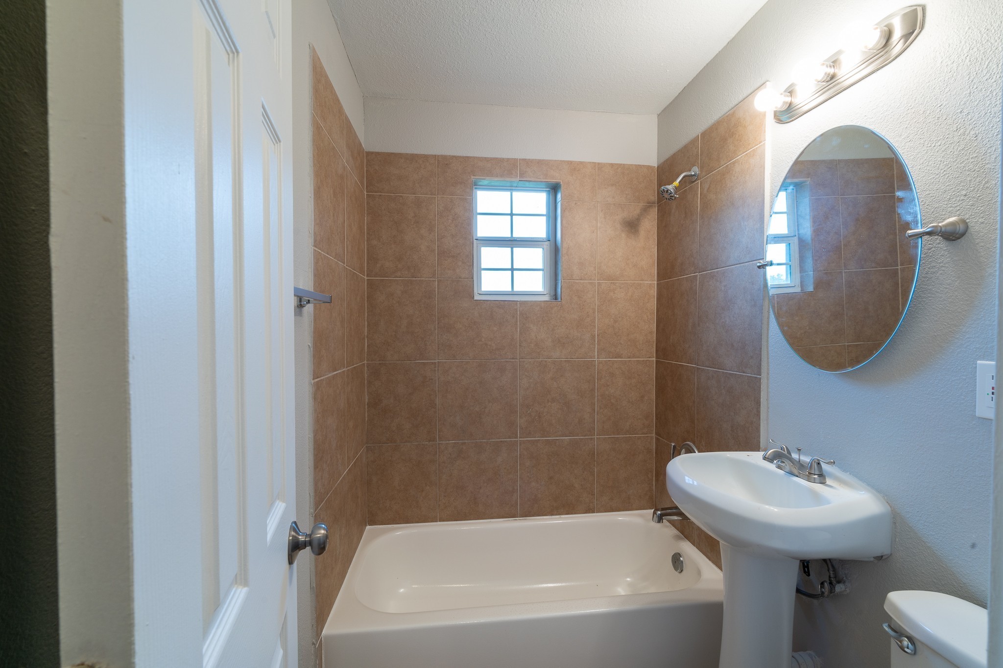 2503 Delano Street, Unit 4 Houston, TX 77004 - Photo 4 of 10 a bathroom with a sink a toilet and a mirror