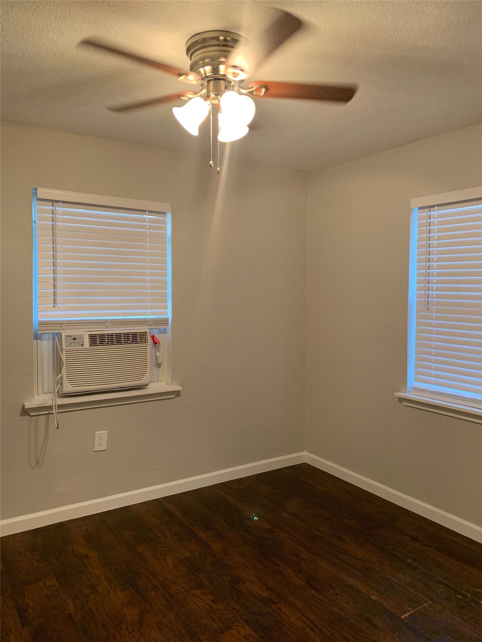 2503 Delano Street, Unit 4 Houston, TX 77004 - Photo 10 of 10 an empty room with wooden floor fan and windows