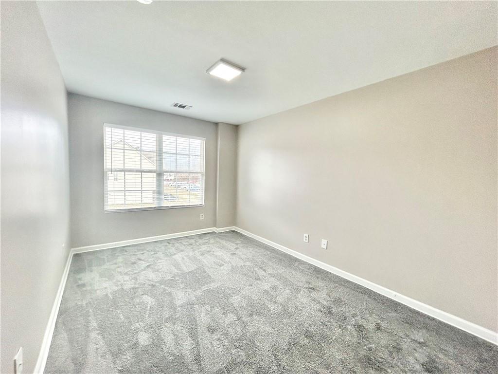 1026 Wheel House Lane, Unit H Monroe, GA 30655 - Photo 11 of 13 an empty room with windows