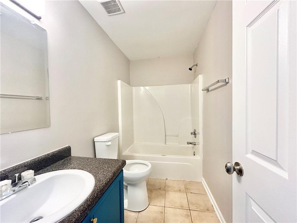 1026 Wheel House Lane, Unit H Monroe, GA 30655 - Photo 8 of 13 a bathroom with a sink toilet tub and shower