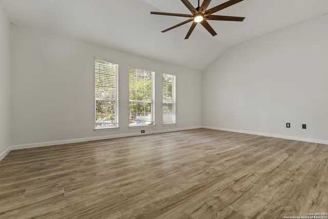 wooden floor in an empty room with a window