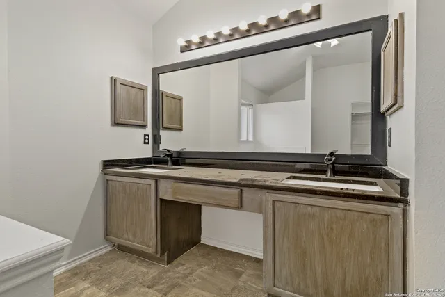 a bathroom with a sink and a mirror