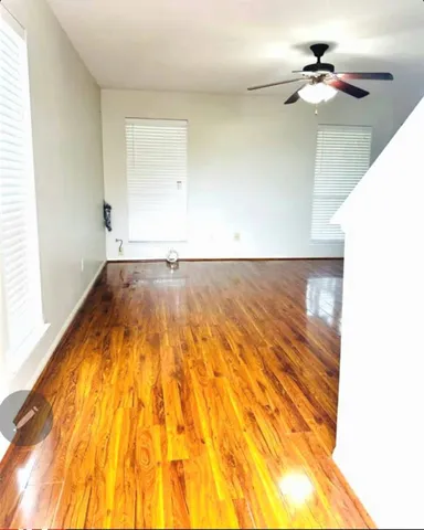 a view of a big room with a ceiling fan