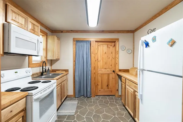 a kitchen with stainless steel appliances granite countertop a stove a refrigerator and a microwave