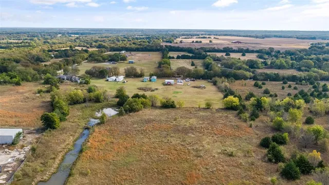 an aerial view of a houses with a yard