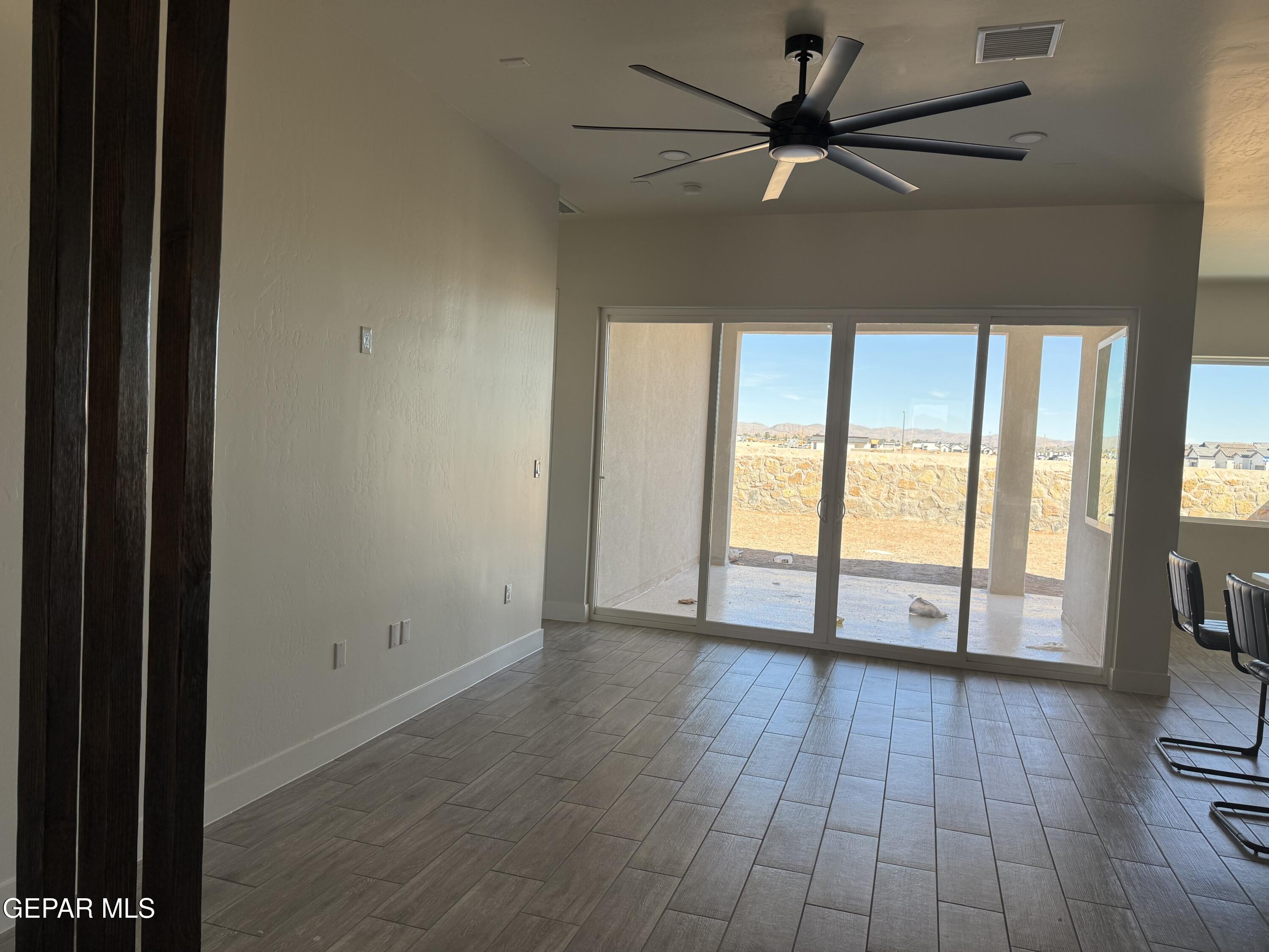 3904 Surmise Street El Paso, TX 79938 - Photo 7 of 21 wooden floor in an empty room with a window