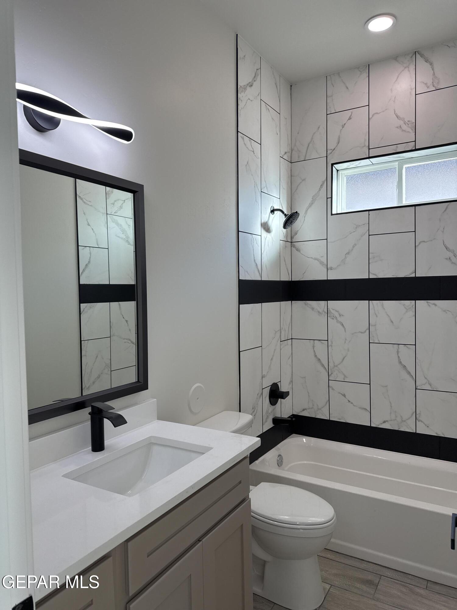 3904 Surmise Street El Paso, TX 79938 - Photo 8 of 21 a bathroom with a sink toilet and shower
