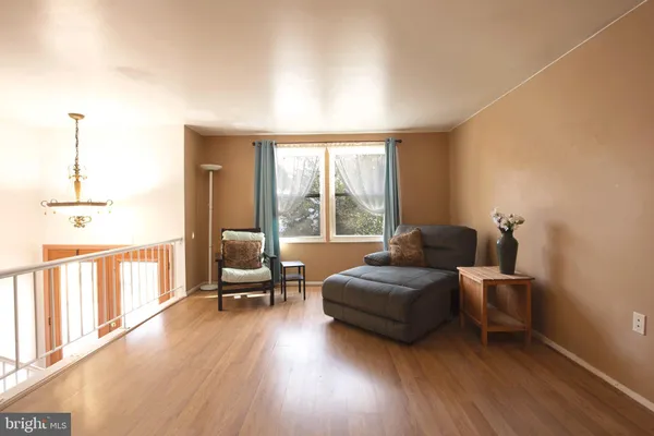 a living room with a bed furniture and a large window