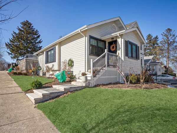 a front view of a house with a yard and porch