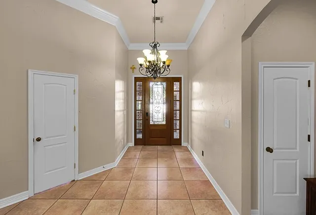 a view of a hallway with chandelier