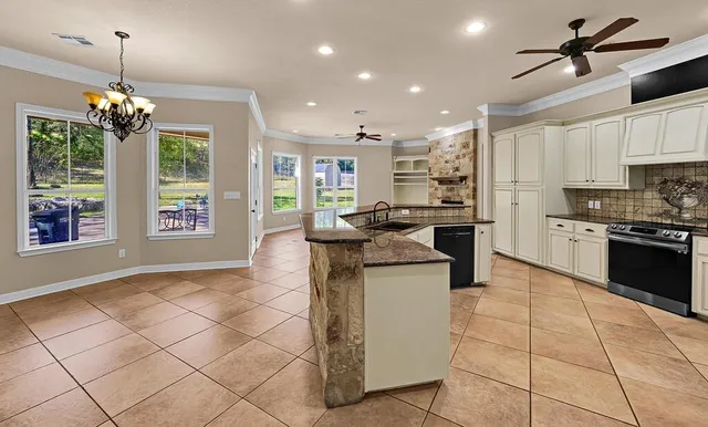 a view of empty room with a fireplace and windows