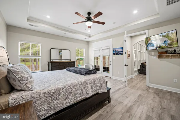 a bedroom with bed and a chandelier
