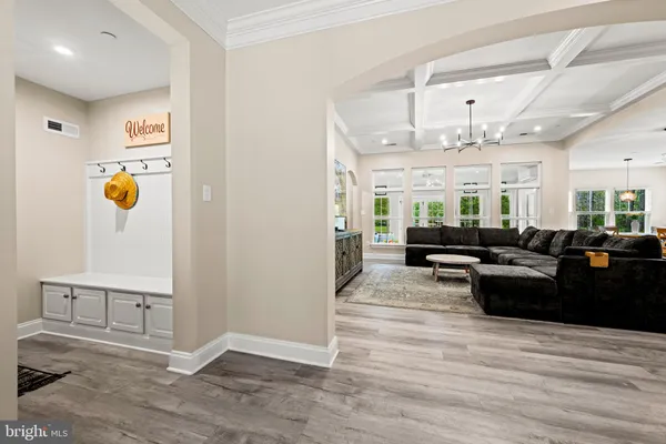 a kitchen with stainless steel appliances a sink a stove a refrigerator cabinets and a window