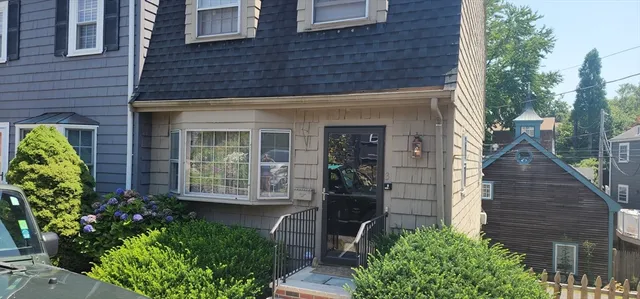 front view of a brick house with a large windows