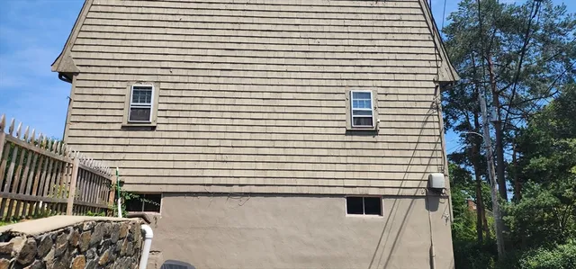a view of a balcony with a chair and a potted plant