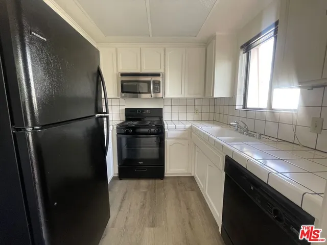 a kitchen with a refrigerator sink and stove