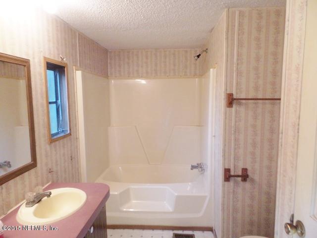 3150 Raulerson Road St. Augustine, FL 32092 - Photo 12 of 19 a bathroom with a sink toilet and shower