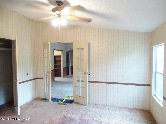 3150 Raulerson Road St. Augustine, FL 32092 - Photo 13 of 19 wooden floor in an empty room with a window