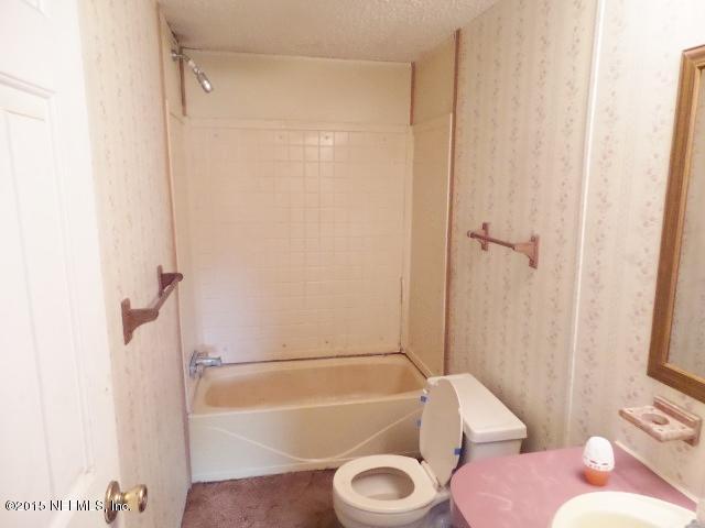 3150 Raulerson Road St. Augustine, FL 32092 - Photo 14 of 19 a bathroom with a granite countertop bathtub shower sink vanity and toilet