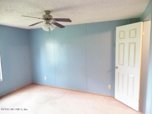 3150 Raulerson Road St. Augustine, FL 32092 - Photo 16 of 19 an empty room with a window and a fan