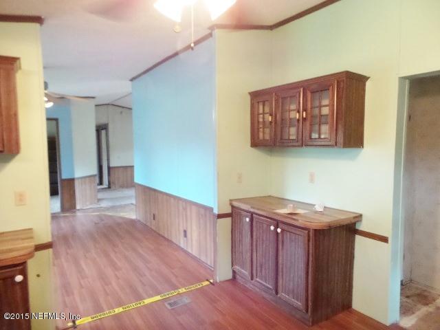 3150 Raulerson Road St. Augustine, FL 32092 - Photo 3 of 19 a view of a hallway with wooden floor and cabinet