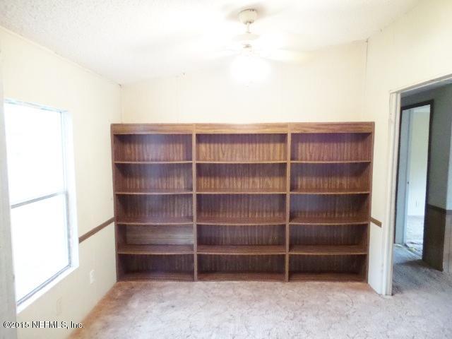 3150 Raulerson Road St. Augustine, FL 32092 - Photo 9 of 19 a view of an empty room with empty shelves