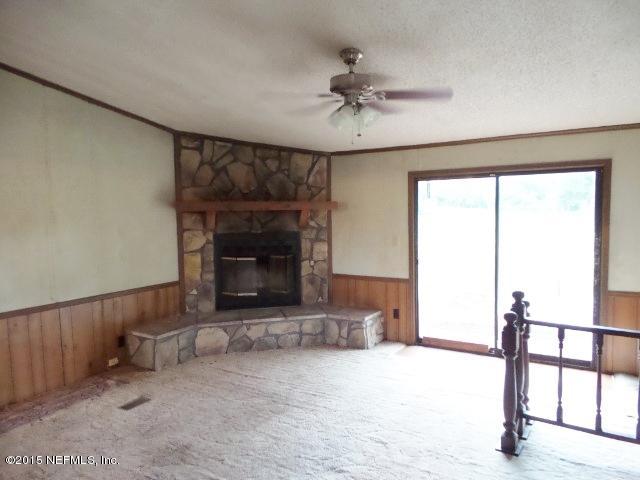 3150 Raulerson Road St. Augustine, FL 32092 - Photo 10 of 19 a living room with furniture and a fireplace