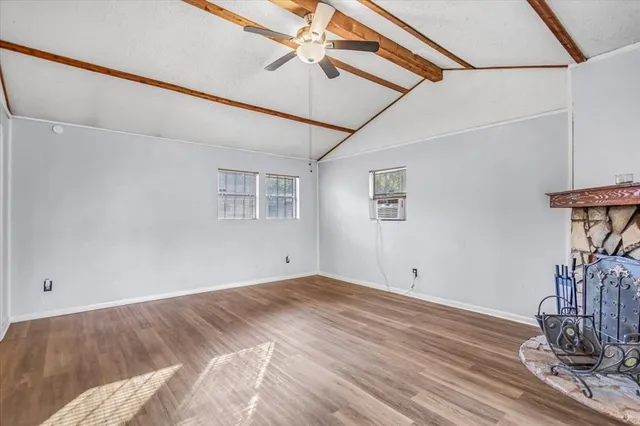 a view of a room with wooden floor