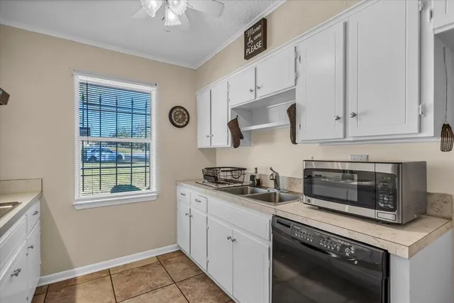 a kitchen with cabinets appliances and a window