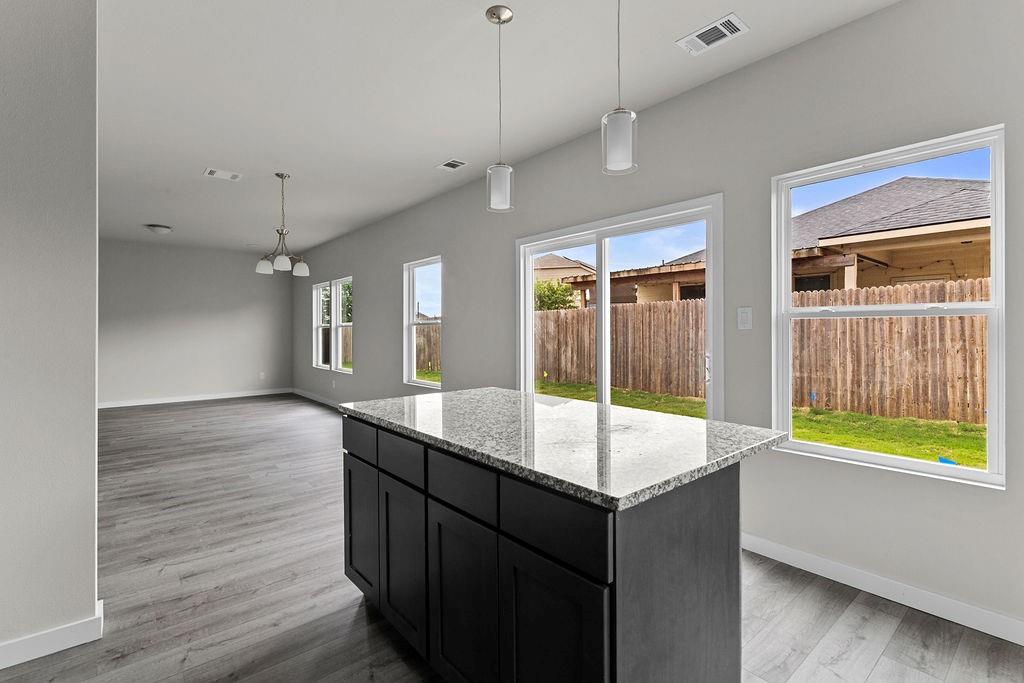 620 Alameda Road Azle, TX 76020 - Photo 8 of 27 a room with wooden floor and window