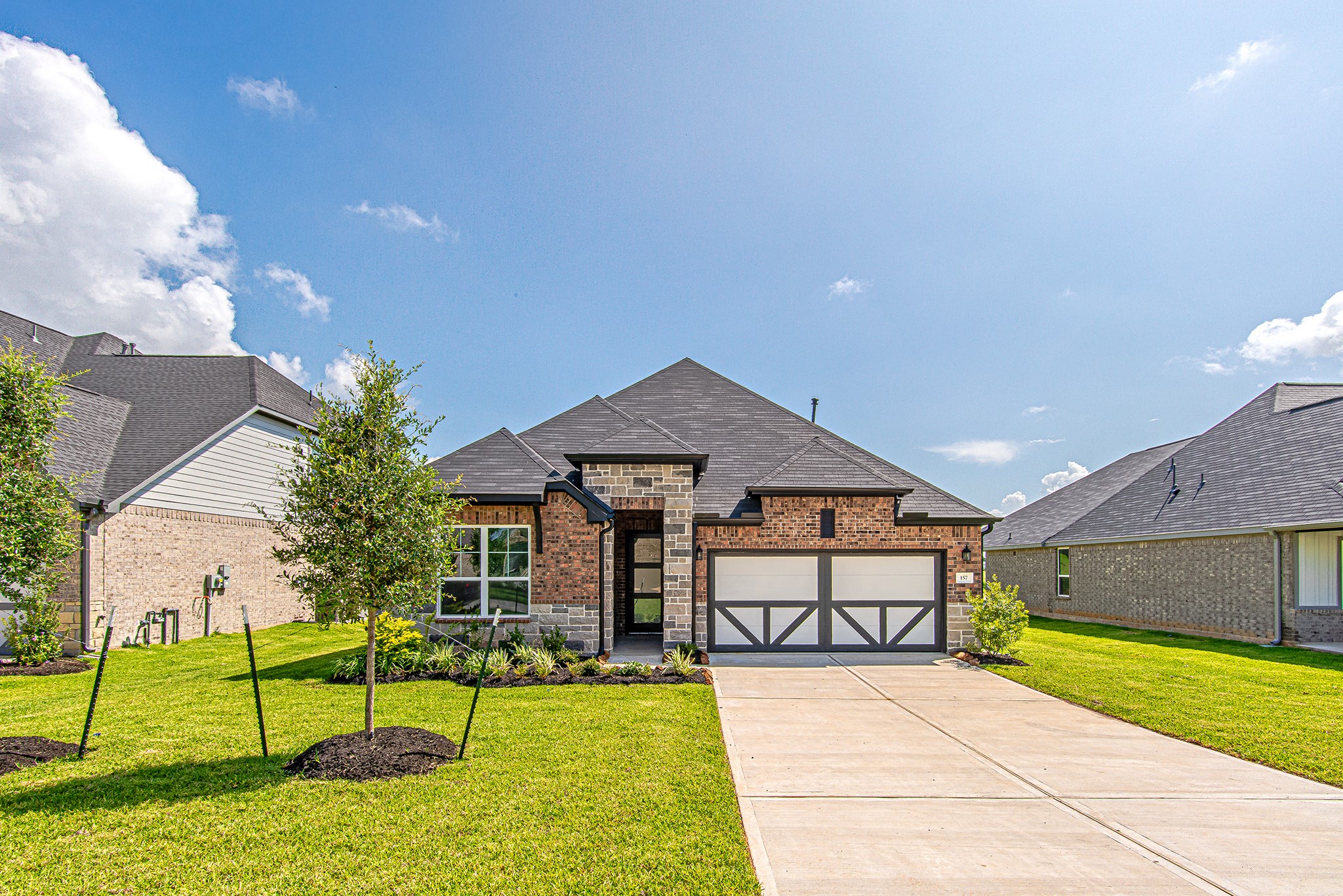 157 Peninsula Point Drive Montgomery, TX 77356 - Photo 1 of 33 a front view of a house with garden