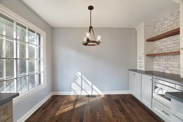 a view of a room with wooden floor cabinets and a window