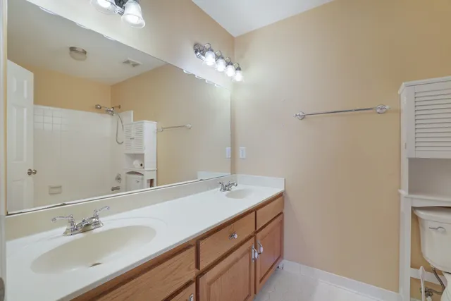 a bathroom with a sink vanity and a mirror