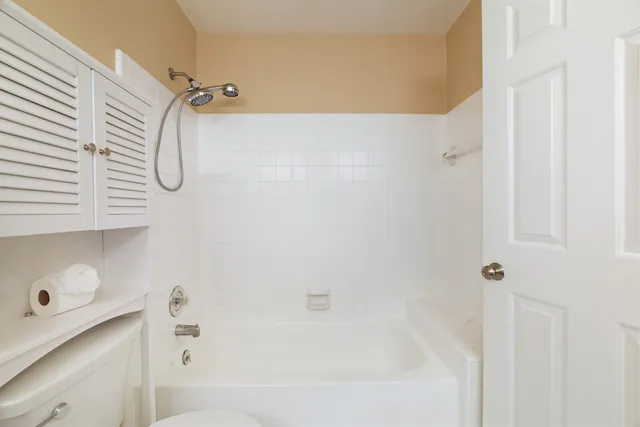 a bathroom with a bath tub with a shower