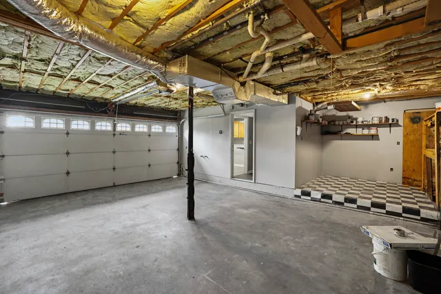 a view of a park with a bench and a tree