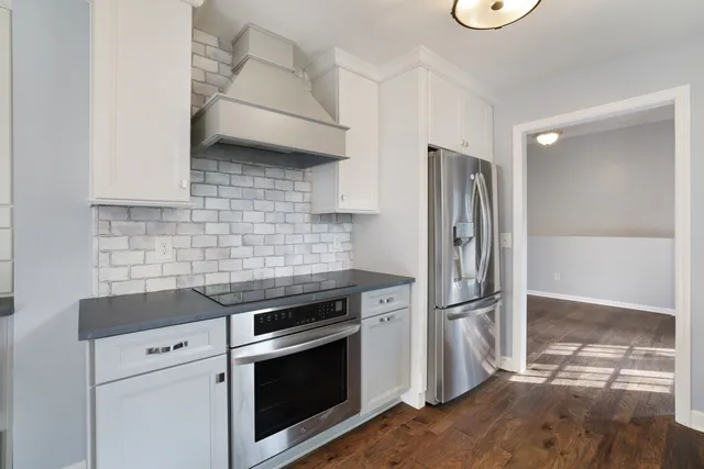 a kitchen with granite countertop a refrigerator and a stove