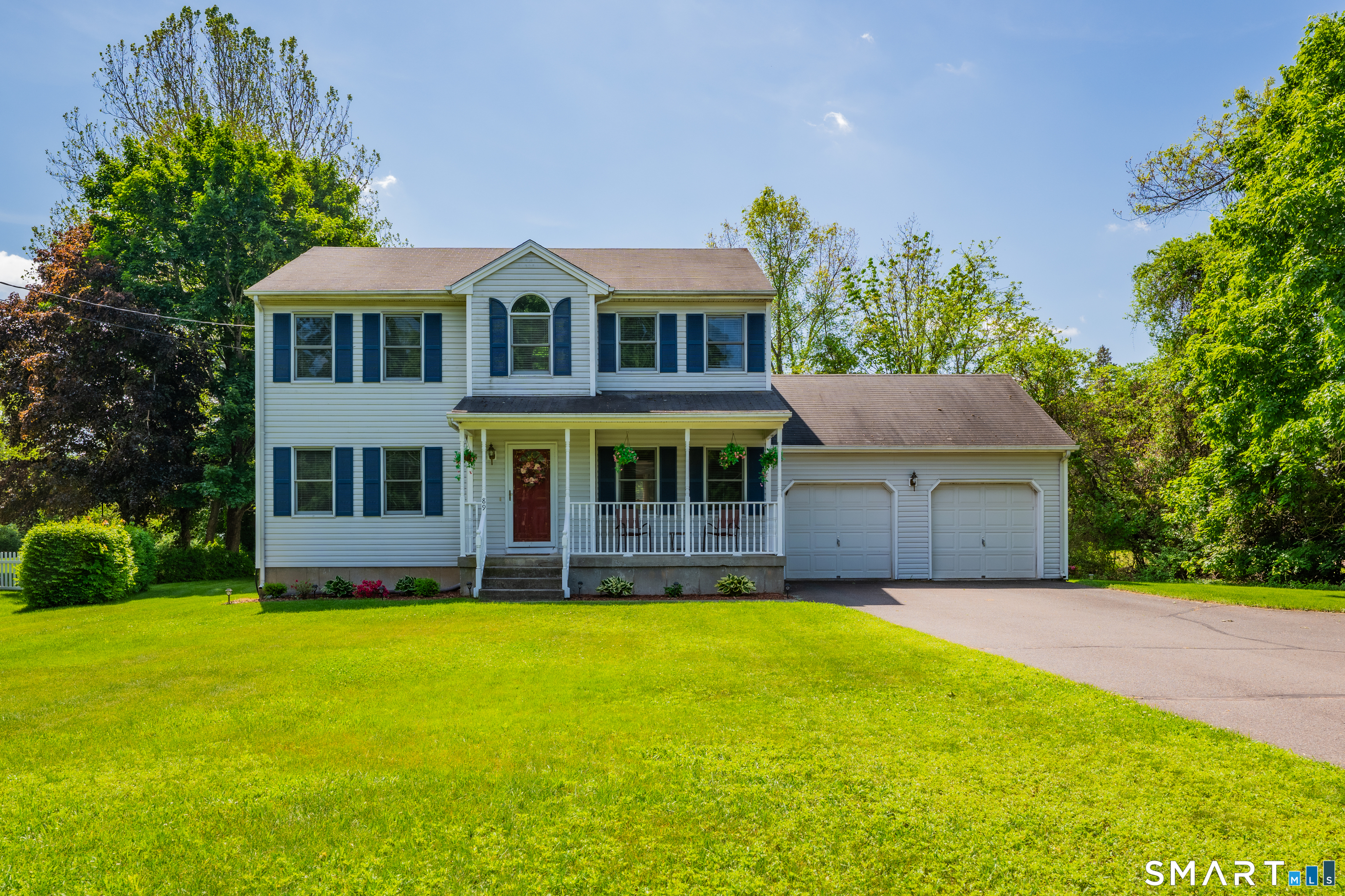 a front view of house with yard and green space