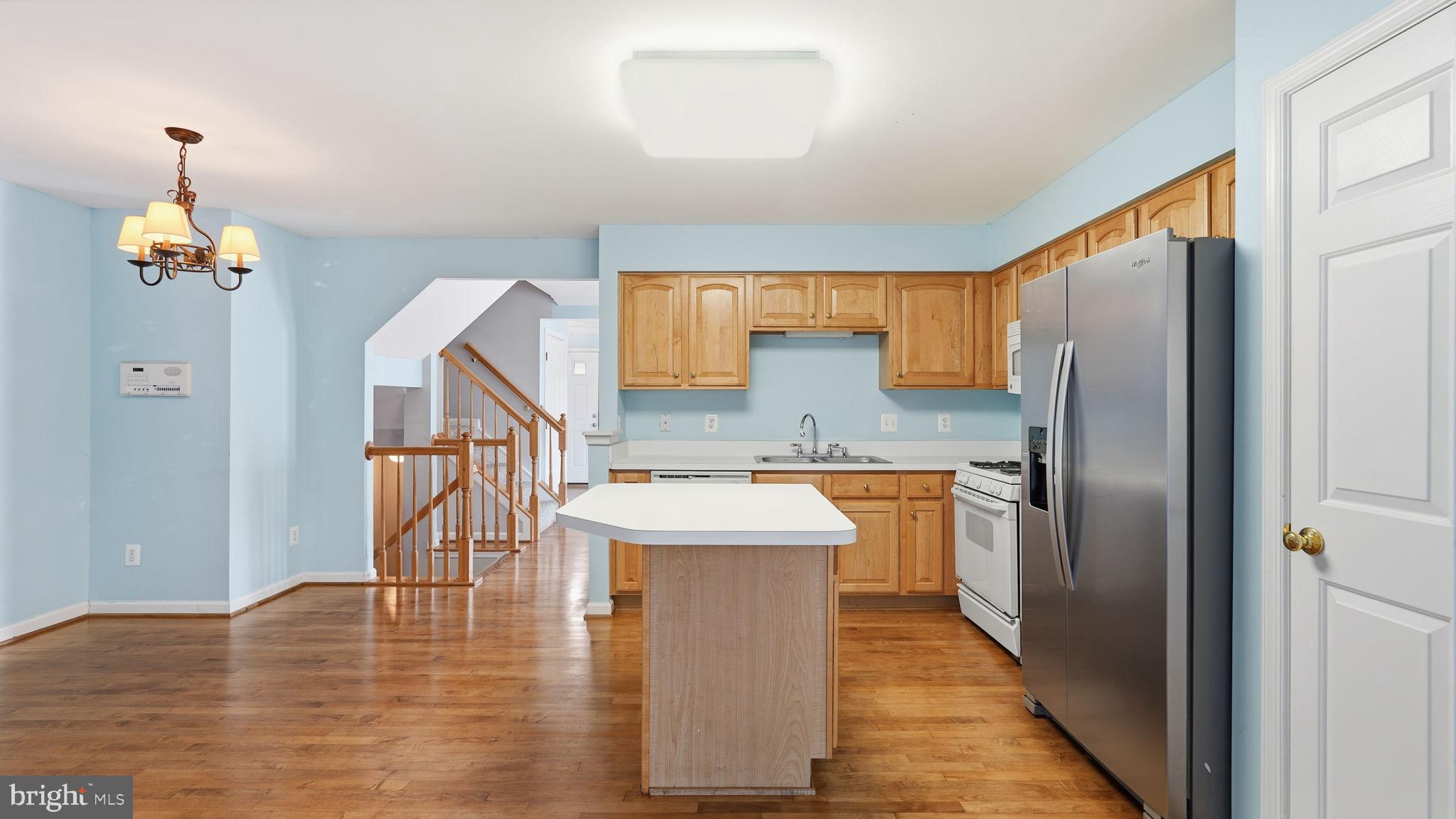 14431 Colonel Wood Road Gainesville, VA 20155 - Photo 14 of 37 a kitchen with stainless steel appliances granite countertop a refrigerator a stove top oven a sink and dishwasher