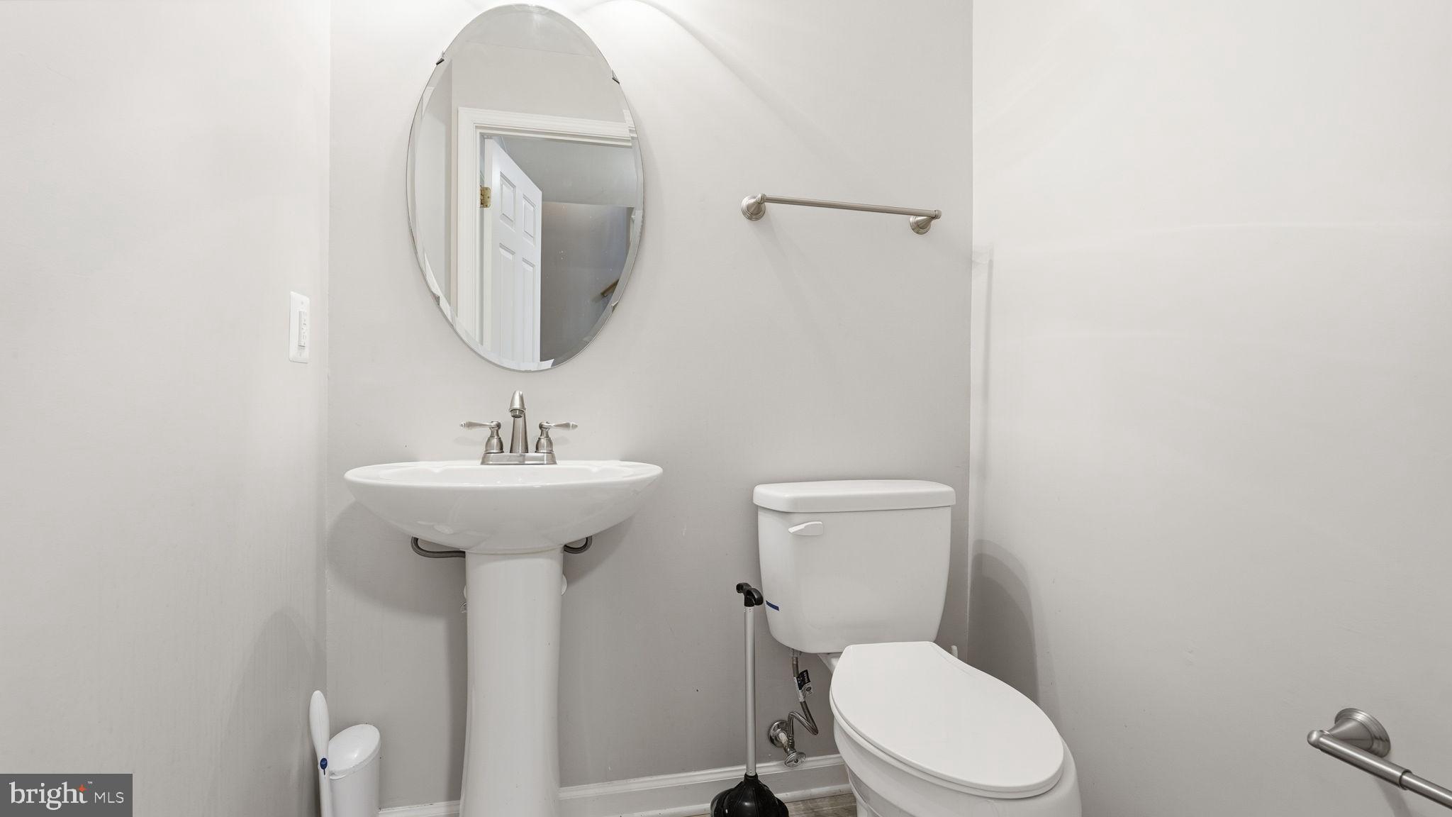 14431 Colonel Wood Road Gainesville, VA 20155 - Photo 25 of 37 a bathroom with a toilet sink and mirror