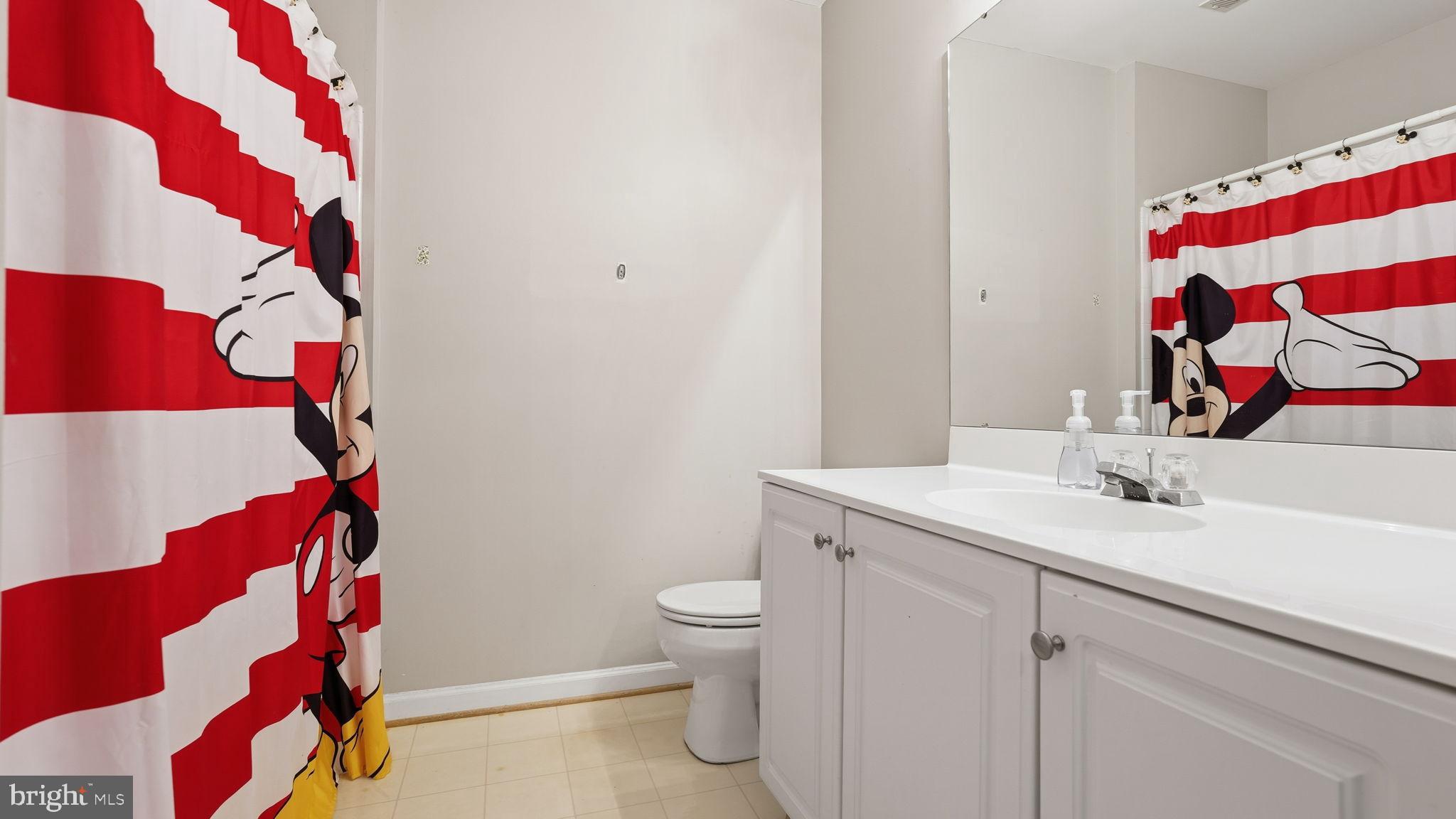 14431 Colonel Wood Road Gainesville, VA 20155 - Photo 26 of 37 a bathroom with a sink toilet and shower curtain
