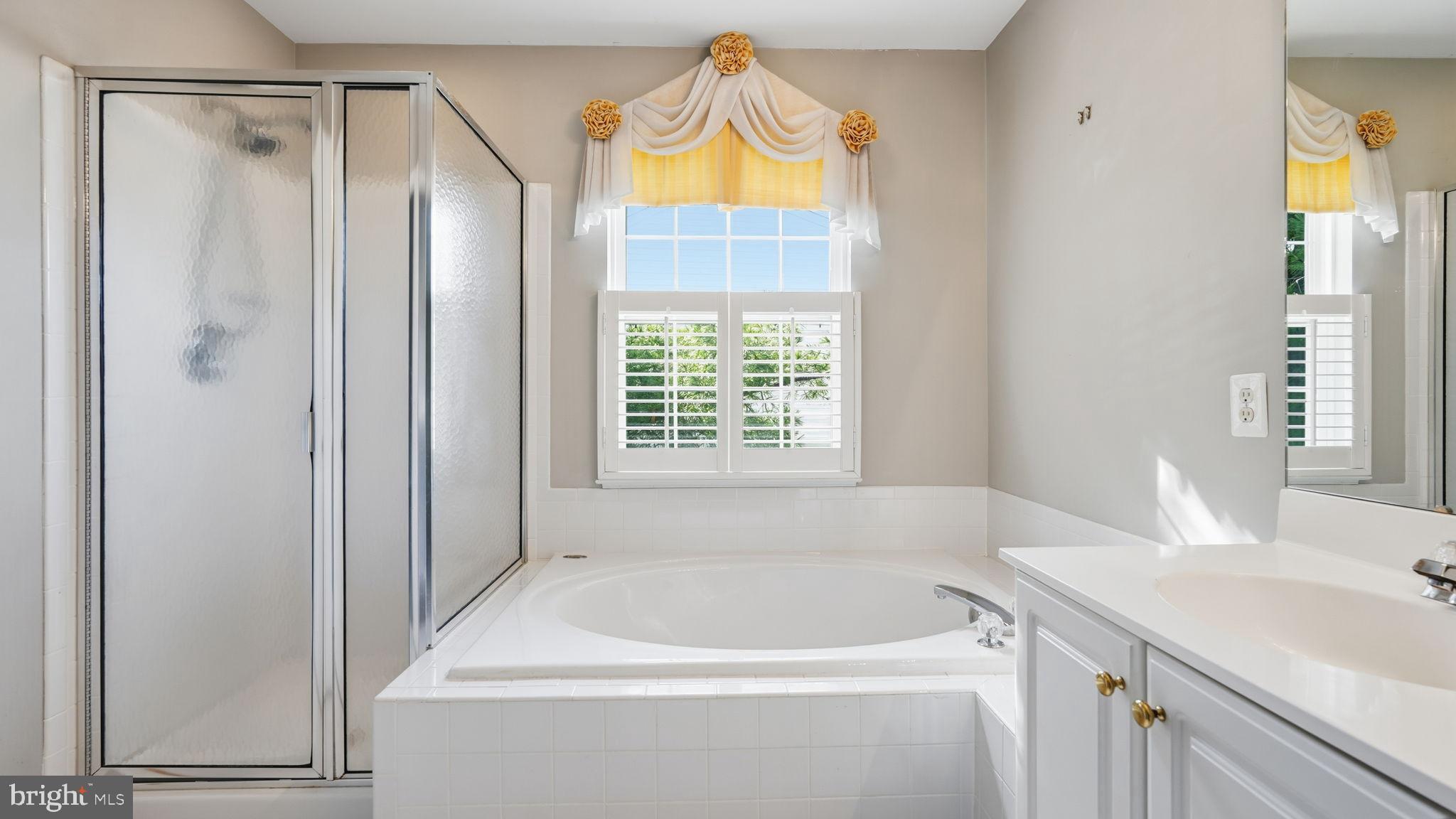 14431 Colonel Wood Road Gainesville, VA 20155 - Photo 27 of 37 a bathroom with a tub a sink and a window