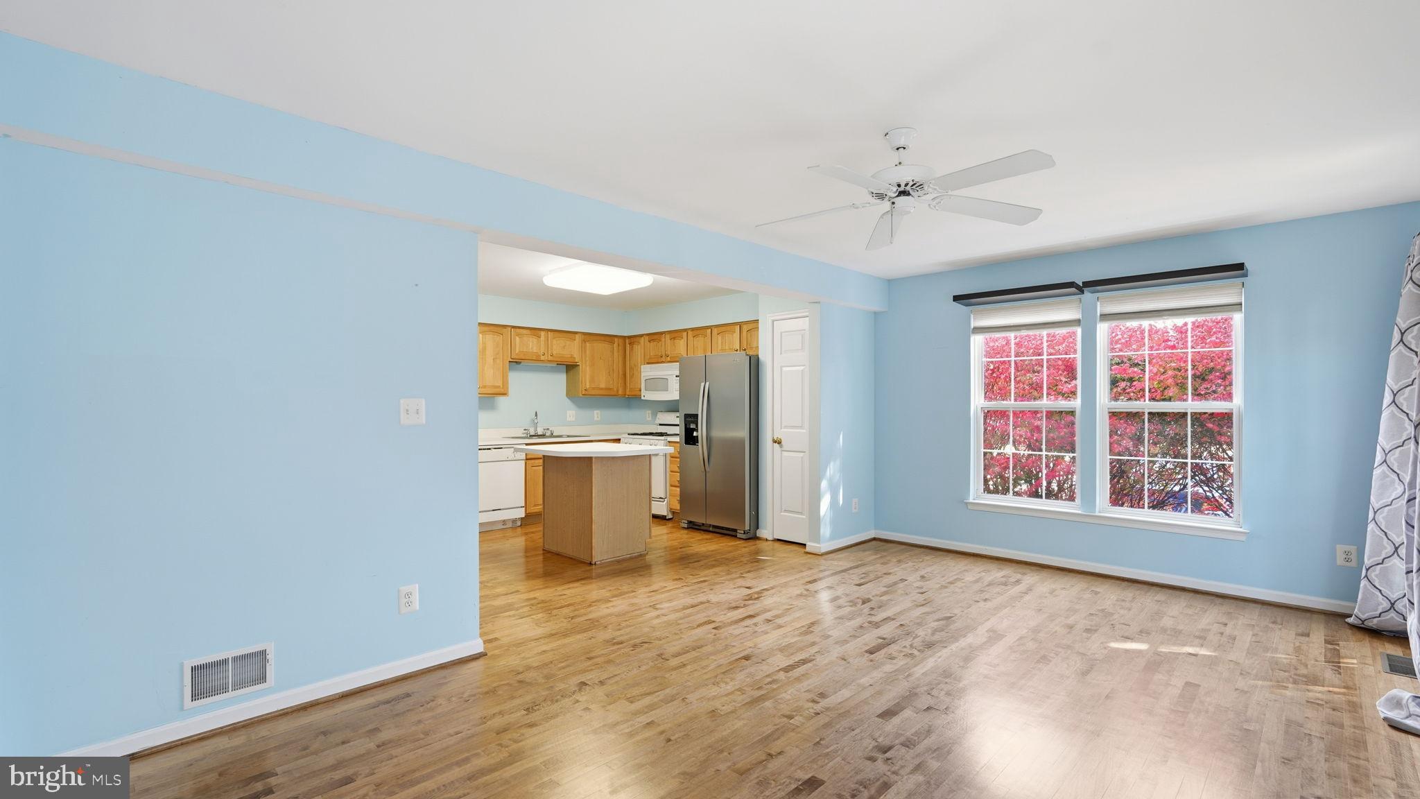 14431 Colonel Wood Road Gainesville, VA 20155 - Photo 10 of 37 wooden floor in an empty room with a kitchen and a window