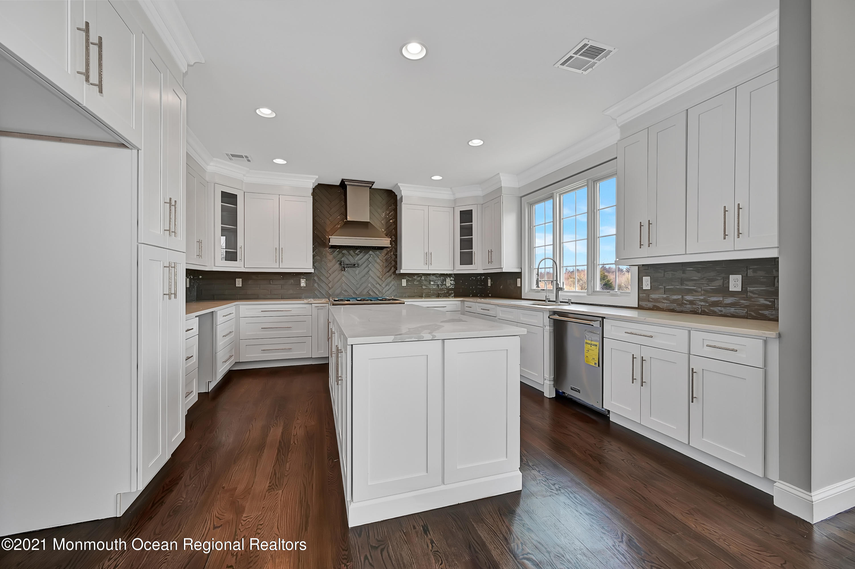 3 Cook Court Millstone Township, NJ 08535 - Photo 17 of 40 a kitchen with kitchen island granite countertop wooden floors white cabinets and stainless steel appliances