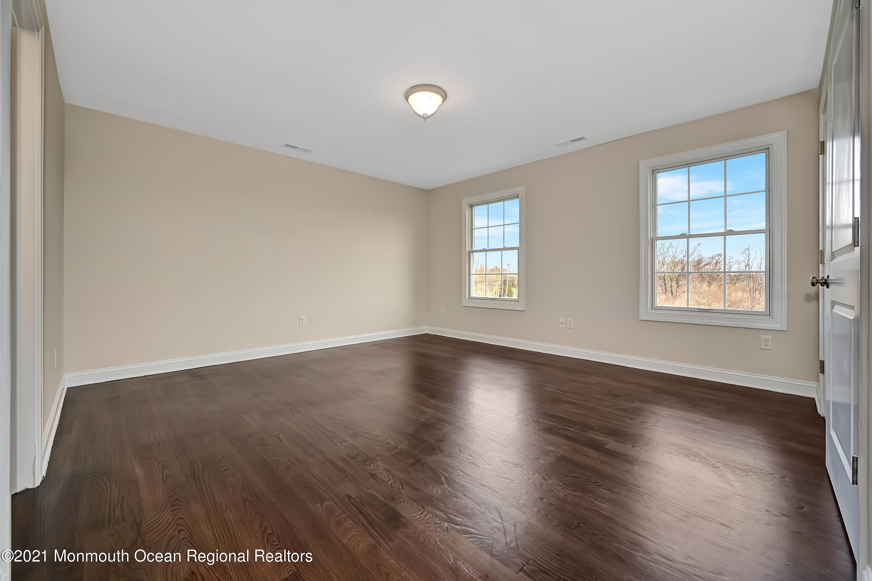 3 Cook Court Millstone Township, NJ 08535 - Photo 24 of 40 an empty room with wooden floor and windows